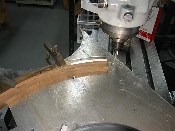  With the stock clamped down, a skim cut is taken from the top to true it to the table surface.